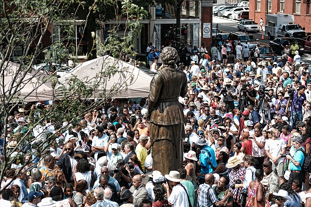 3. The jubilant crowd encircles the statue for a closer look and photos after the ceremony.