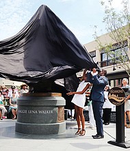 1. Sculptor Antonio “Toby” Mendez, left, assists Richmond Mayor Levar M. Stoney and Liza Mickens, Mrs. Walker’s great- great-granddaughter in unveiling the statue.