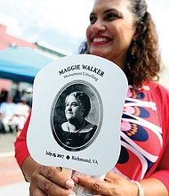 6. Richmond City Councilwoman Kimberly B. Gray holds one of the commemorative fans given out to the crowd in the 90-degree-plus heat.