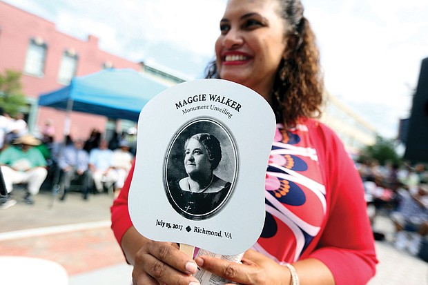 6. Richmond City Councilwoman Kimberly B. Gray holds one of the commemorative fans given out to the crowd in the 90-degree-plus heat.