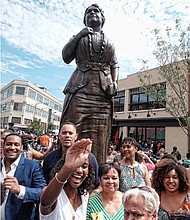 8. Liza Mickens, her brother, Johnny Mickens IV, left, and other Walker descendants greet friends after the ceremony.