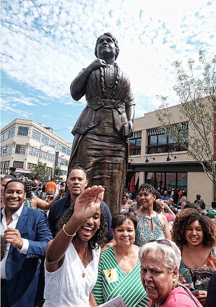 8. Liza Mickens, her brother, Johnny Mickens IV, left, and other Walker descendants greet friends after the ceremony.