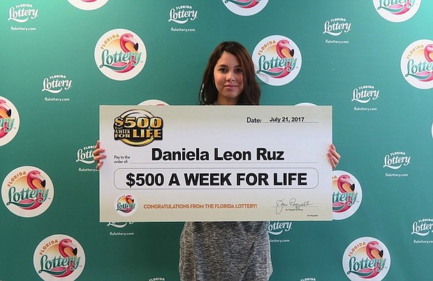 	Daniela Leon Ruz of Orlando holding a check for $500 a week for life.