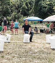 Cultivating musical interest //
Shyamuu Bhagat leads youngsters in a bucket drum workshop last Saturday at “Drums in the Garden,” an event at the 5th District Mini Farm on Bainbridge Street in South Side to promote urban farming and healthy eating.