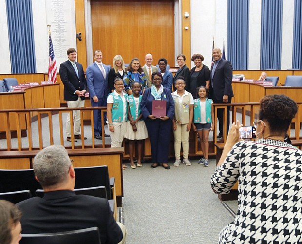 
Honoring historic Girl Scout troops
Scout leader Glennys Fleming, center, holds the resolution honoring Girl Scout Troops #34 and #35 that was presented Monday night by Richmond City Council to Ms. Fleming and several scouts from the troops sponsored by Ebenezer Baptist Church. Historic Troop #34, the first African-American troop in the South, was chartered in March 1932 after Emma Watson wanted her daughter to participate in scouting as she had before moving to Richmond from Chicago. With the support of influential Richmond women such as Maggie L. Walker and Lena Watson, dean of students at Virginia Union University, Ms. Watson advocated for the local Girl Scouts council to create a local African-American troop. It met at VUU. In 1936, Troop #35 was established at Ebenezer Baptist Church, which began sponsoring Troop #34 in 2015.
