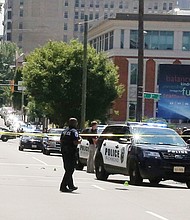 Cityscape // Crime tape and police and firefighters in action are all too common in Richmond and other cities. Above, officers and police cars pack the intersection of 3rd and Main streets in Downtown around 10:30 a.m. Tuesday following the police shooting of a man wielding a large knife and an ax. Police Chief Alfred Durham said officers shot the man when he did not respond to commands to drop the weapons, and a Taser proved ineffective in stopping him. When the man attacked the officers, two fired, hitting him. The man, later identified as Alexander J. Schoessel, 23, of Chesterfield, was pronounced dead at 10:31 a.m. Tuesday at a Richmond hospital. Officer John Rotondi also was hit by friendly fire during the incident. He was taken to a hospital, where he was treated and released. Right, firefighters hose down a smoldering pile of driftwood Tuesday afternoon underneath a pedestrian bridge across the James River that connects Brown’s Island and Belle Isle in Downtown. 