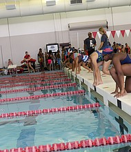 Girls get in the starting position for a race at Splashdown, a friendly swim meet hosted by the Harris County Aquatics Program on July 28.