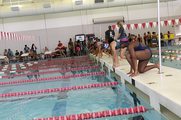 Girls get in the starting position for a race at Splashdown, a friendly swim meet hosted by the Harris County Aquatics Program on July 28.