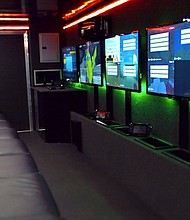 	This photograph shows the interior of one of Gametruck's video game trailers.