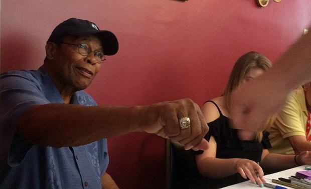 Rod Carew fist bumps one of his many well-wishers during Hall of Fame weekend.