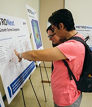 Open house attendee learns about regional population growth.