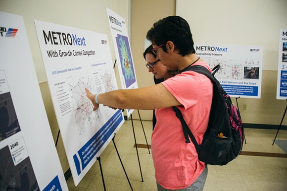 Open house attendee learns about regional population growth.
