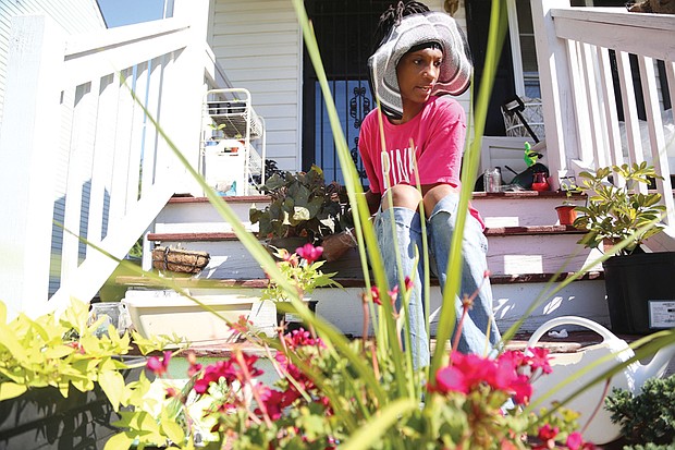 Cityscape // Gardening is a popular summer pastime in Richmond. Here, Monica Burton prepares to add new flowers to the plantings at her home in the 1900 block of Bainbridge Street in the Paradise Place neighborhood in South Side. 