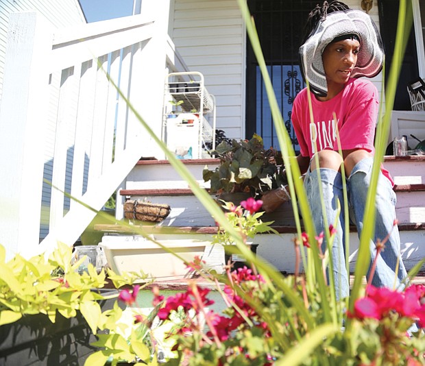 Cityscape // Gardening is a popular summer pastime in Richmond. Here, Monica Burton prepares to add new flowers to the plantings at her home in the 1900 block of Bainbridge Street in the Paradise Place neighborhood in South Side. 