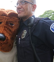 National Night Out // People across the city came together with police officers and emergency medical personnel at block parties, cookouts and other neighborhood activities. Below, Richmond Police Officer Juan Tejeda hugs McGruff the Crime Dog, who was a hit with youngsters at the North Side event. 
