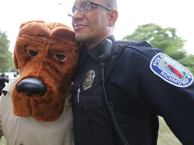 National Night Out // People across the city came together with police officers and emergency medical personnel at block parties, cookouts and other neighborhood activities. Below, Richmond Police Officer Juan Tejeda hugs McGruff the Crime Dog, who was a hit with youngsters at the North Side event. 
