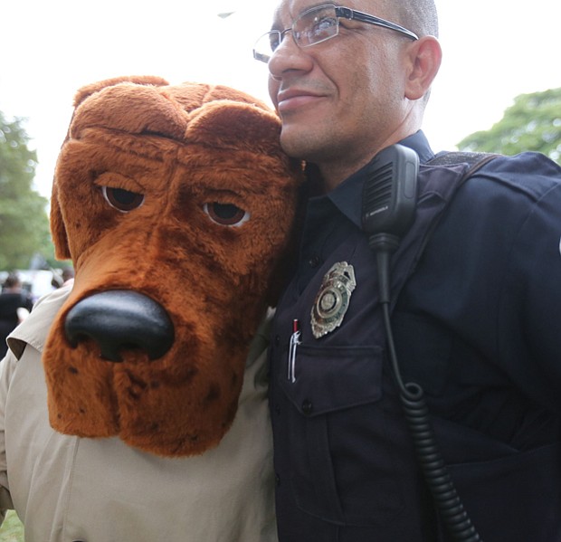 National Night Out // People across the city came together with police officers and emergency medical personnel at block parties, cookouts and other neighborhood activities. Below, Richmond Police Officer Juan Tejeda hugs McGruff the Crime Dog, who was a hit with youngsters at the North Side event. 
