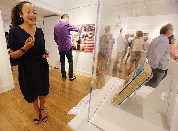 The RVA Latino experience //
Curator Wanda Hernandez, left, talks about a new exhibit, “Nuestras Historias: Latinos in Richmond,” at The Valentine in Downtown during a Free Family Day celebration last Saturday. The exhibit shares the story of Richmond’s Latino population of approximately 100,000 through interviews, objects and images. The celebration featured the music of Bio Ritmo.