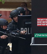 Armed police are seen outside the Lindt Cafe, Martin Place 