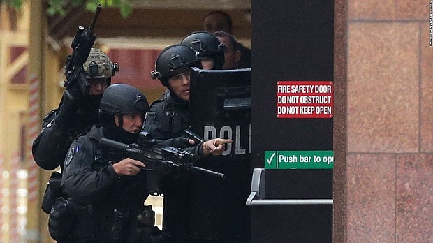 Armed police are seen outside the Lindt Cafe, Martin Place 