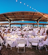 
Dîner en Blanc
More than 900 people dine al fresco in white during Richmond’s inaugural Dîner en Blanc last Saturday at the Science Museum of Virginia on West Broad Street. Invited guests bring white chairs, tablecloths and picnic baskets to the pop-up picnic, the location of which is kept secret until the last moment. Guests then converge on the location and unpack their picnic carts — no plastic plates or utensils allowed — to elegantly dine under the stars to music. According to the Paris tradition where the impromptu event began nearly 30 years ago, everyone must dress in white. 

Photo by Tri D. Pham //
