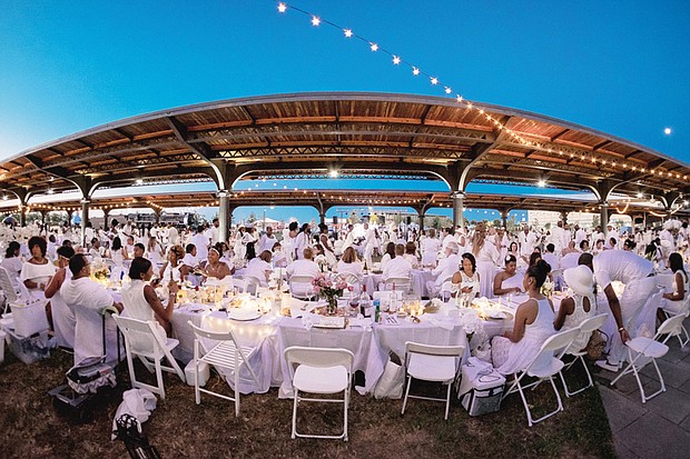 
Dîner en Blanc
More than 900 people dine al fresco in white during Richmond’s inaugural Dîner en Blanc last Saturday at the Science Museum of Virginia on West Broad Street. Invited guests bring white chairs, tablecloths and picnic baskets to the pop-up picnic, the location of which is kept secret until the last moment. Guests then converge on the location and unpack their picnic carts — no plastic plates or utensils allowed — to elegantly dine under the stars to music. According to the Paris tradition where the impromptu event began nearly 30 years ago, everyone must dress in white. 

Photo by Tri D. Pham //
