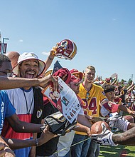 Washington tight end Vernon Davis, a two-time Pro Bowl selection who is now in his 12th season in the NFL, signs autographs for excited fans Saturday during Fan Appreciation Day at the Bon Secours Training Center in Richmond.