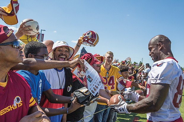 Washington tight end Vernon Davis, a two-time Pro Bowl selection who is now in his 12th season in the NFL, signs autographs for excited fans Saturday during Fan Appreciation Day at the Bon Secours Training Center in Richmond.