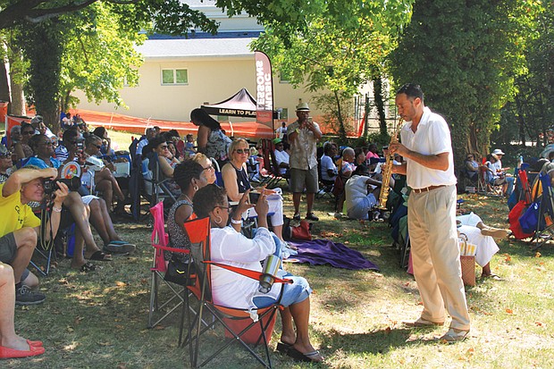 Photo by Ronald E. Carrington
Playing to the crowd
Smooth jazz saxophonist Rick Elliott plays for an appreciative crowd last Saturday at St. Elizabeth Catholic Church’s 9th Annual Jazz and Food Festival. Food trucks served up dishes and beverages while performers serenaded the crowd in Highland Park. Money raised by the festival supports the church’s programs.