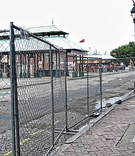 
Fencing blocks off 17th Street and the Farmers’ Market — the first step in a $4.3 million facelift that will transform the street and the marketplace between Main and Franklin streets into a European-style plaza. Despite the work, restaurants and shops that face the market remain open for business, with owners and operators hoping customers will continue to stop by. The transformation is expected to be finished by March. When done, the revamped market is to be the outdoor extension of nearby Main Street Station, whose interior has been redone and includes a huge, glass-faced event space, a soon-to-open tourist welcome center and room for retail shops. The project is part of the city’s spending to rejuvenate the Shockoe Bottom area. Nearby to the west, the city plans to invest more than $19 million to develop a museum-style space to recall Richmond’s role in the slave trade more than 150 years ago. 