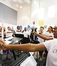 VSU band director James Holden, left, works with piccolo player Gianna Green, right, and other woodwind players during a rehearsal last week in Davis Hall.
