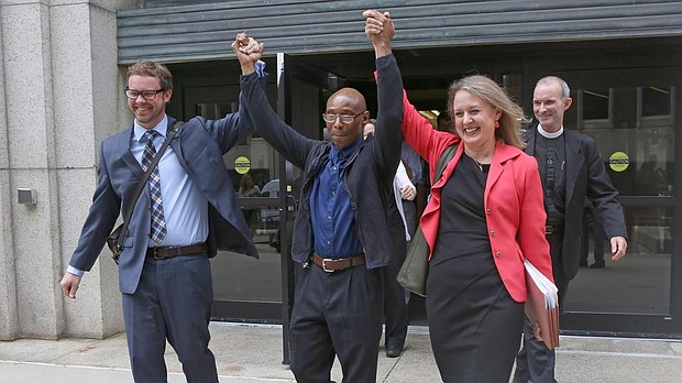 Frederick Clay, center, who was wrongfully convicted of a 1979 murder, leaves Suffolk Superior Court with attorneys Jeff Harris, left, and Lisa Kavanaugh yesterday. (photo credit: Angela Rowlings)