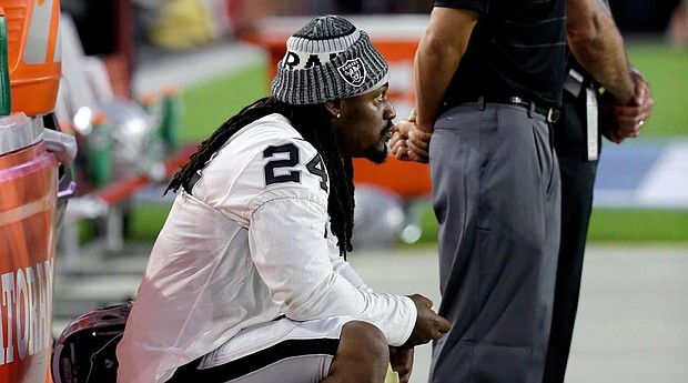 Oakland Raiders running back Marshawn Lynch (24) sits during the national anthem prior to the team’s NFL preseason football game against the Arizona Cardinals, Saturday, Aug. 12, 2017, in Glendale, Ariz. (AP Photo/Rick Scuteri)