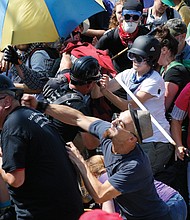 White nationalists clash with equality supporters last Saturday at the entrance to Emancipation Park in Charlottesville. Such clashes went on for at least 90 minutes before officials declared the event an unlawful assembly.