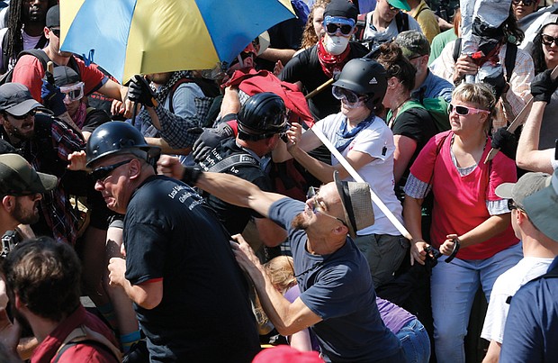 White nationalists clash with equality supporters last Saturday at the entrance to Emancipation Park in Charlottesville. Such clashes went on for at least 90 minutes before officials declared the event an unlawful assembly.