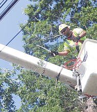 Cityscape // Tree pruning is now underway to help protect power lines throughout the city. Left, Ron Branch, a lift foreman, is among the workers removing branches that could knock down lines in a storm. He is an employee of Pennsylvania-based Asplundh Tree Expert Co., one of the private contractors Dominion Energy has hired to do the work. Asplundh general foreman David Fox describes the work as “regular maintenance to help keep customers’ lights on.”
 