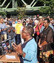 At right, Dr. Cheryl Ivy Green, president of the Baptist Ministers’ Conference of Richmond and Vicinity, leads people in prayer at the gathering where clergy members joined politicians, including Gov. Terry McAuliffe, far right, and Delegate Delores L. McQuinn of Richmond, second from right, and Congressman A. Donald McEachin.