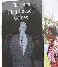 Lisa Gaines McDonald admires the monument honoring her late father, Coach Clarence “Big House” Gaines, following its unveiling last week in Coleman Park in Paducah, Ky.