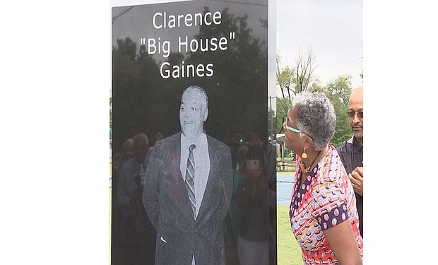 Lisa Gaines McDonald admires the monument honoring her late father, Coach Clarence “Big House” Gaines, following its unveiling last week in Coleman Park in Paducah, Ky.