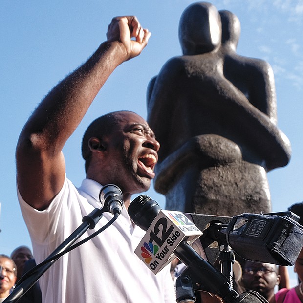 Reconciliation rally // Richmond Mayor Levar M. Stoney addresses a crowd of hundreds Sunday during a solidarity rally at Richmond’s Slavery Reconciliation Statue at 15th and Main streets in Shockoe Bottom. Participants at the hour long vigil remembered the victims of the weekend’s violent clashes in Charlottesville over that city’s planned removal of Confederate statues. They also prayed for President Trump and direction in the ongoing battle against racism and hatred. 