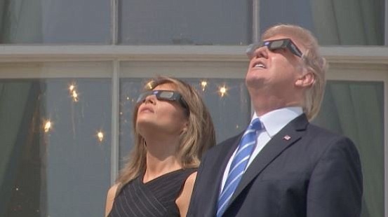 
President Donald Trump and first lady Melania Trump wear glasses to watch the solar eclipse