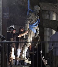 A statue of Confederate Gen. Robert E. Lee is removed from the University of Texas campus early Monday morning in Austin. (Eric Gay/AP)