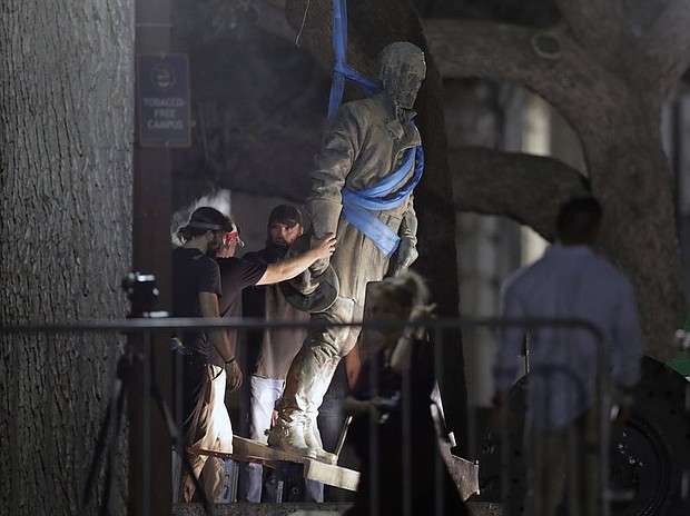 A statue of Confederate Gen. Robert E. Lee is removed from the University of Texas campus early Monday morning in Austin. (Eric Gay/AP)