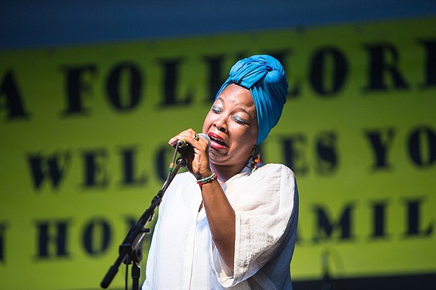 A ‘Down Home’ gathering //
The Elegba Folklore Society delivered food, entertainment and opportunities to support local vendors at its 27th Annual Down Home Family Reunion on Saturday in Jackson Ward’s Abner Clay Park. Above, a singer with the Washington-based Full Power Blues performs traditional and dance blues music with the group’s signature style.