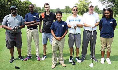 Glenwood Academy students greet golf foursomes during the school’s 130th Anniversary Pro-Am event at Flossmoor Country Club on Aug. 2, 2017. (Photo provided by Glenwood Academy)