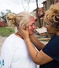 Genice Gipson, right, comforts her lifelong friend Loretta Capistran, outside Ms. Capistran’s apartment complex in Refugio, Texas, on Monday.
