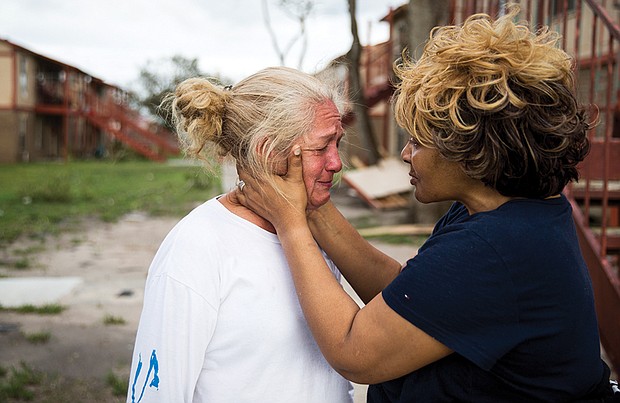 Genice Gipson, right, comforts her lifelong friend Loretta Capistran, outside Ms. Capistran’s apartment complex in Refugio, Texas, on Monday.
