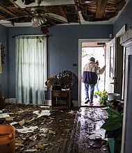 Lucas Garcia walks out of his home Saturday in Refugio, Texas, where he and other family members rode out Hurricane Harvey in one room.
