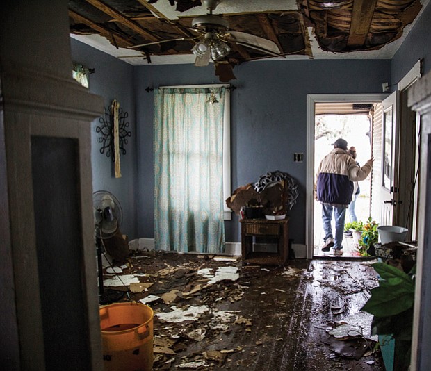 Lucas Garcia walks out of his home Saturday in Refugio, Texas, where he and other family members rode out Hurricane Harvey in one room.
