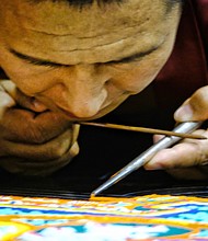 The Tibetan Buddhist tradition begins with chanting and laying out the mandala, then placing the sand, which is painted. The monks held public meditation sessions each evening as the mandala was created. During the Aug. 20 closing ceremony, the mandala was dismantled to symbolize the belief in the transitory nature of material life. Small packets of sand were given to members of the audience. 